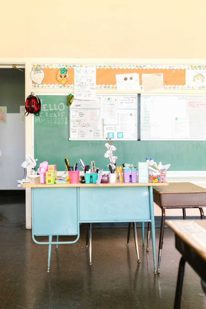 services-04 Inviting classroom with a green chalkboard, desks, and colorful school supplies.